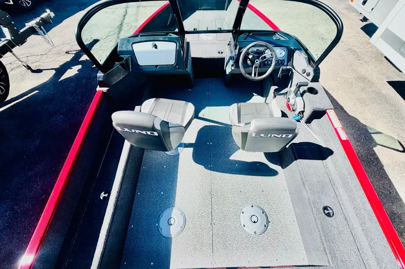 Slide: The Image of 2026 Lund 1650 Angler Sport interior with dual seats and steering console. - 7