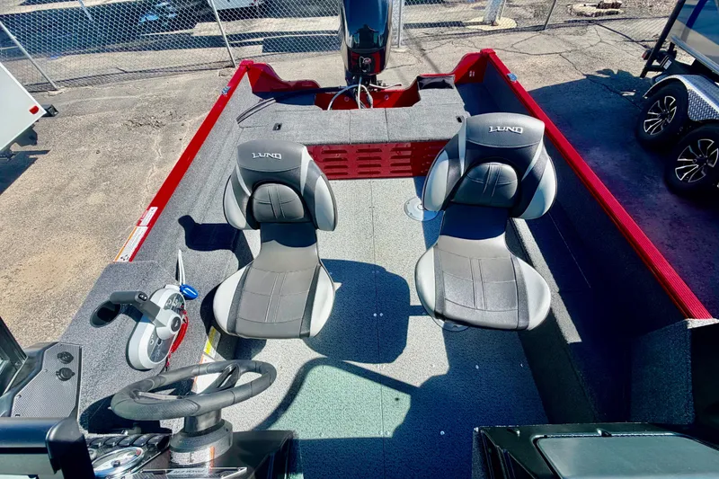 Slide: The Image of 2026 Lund 1650 Angler Sport boat interior with two seats and steering console. - 8
