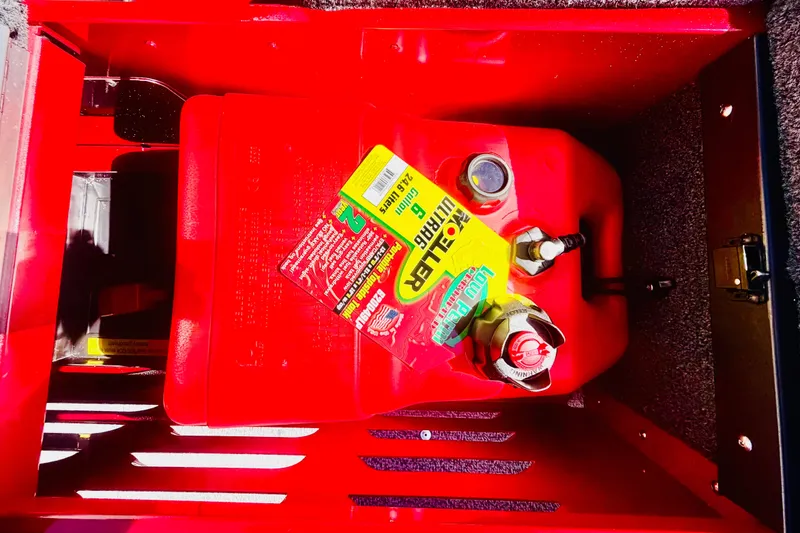 Slide: The Image of Red fuel tank inside a 2026 Lund 1650 Angler Sport boat compartment. - 9