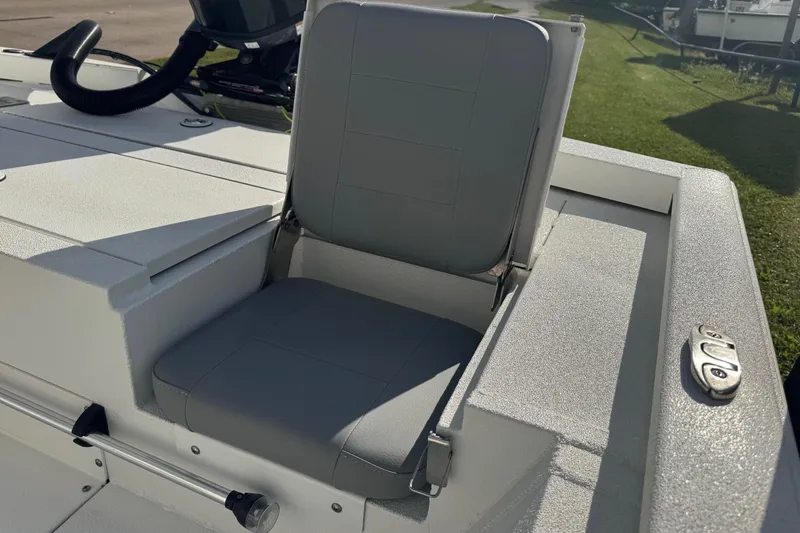 Slide: The Image of 2022 Avid 19 FS boat seat with sleek gray upholstery and modern design. - 10