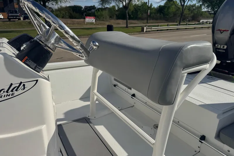 Slide: The Image of 2022 Avid 19 FS boat helm with gray seat and steering wheel. - 12