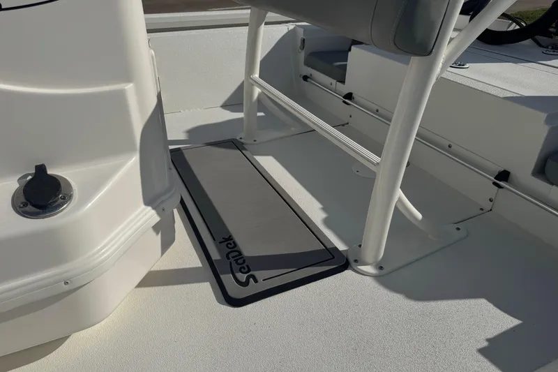 Slide: The Image of Interior of 2022 Avid 19 FS boat featuring SeaDek flooring and seating area. - 13
