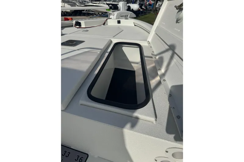 Slide: The Image of 2022 Avid 19 FS boat deck with open storage compartment. - 16