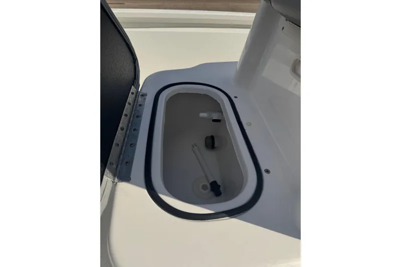 Slide: The Image of Open storage compartment on 2022 Avid 19 FS boat, featuring a clean interior design. - 19