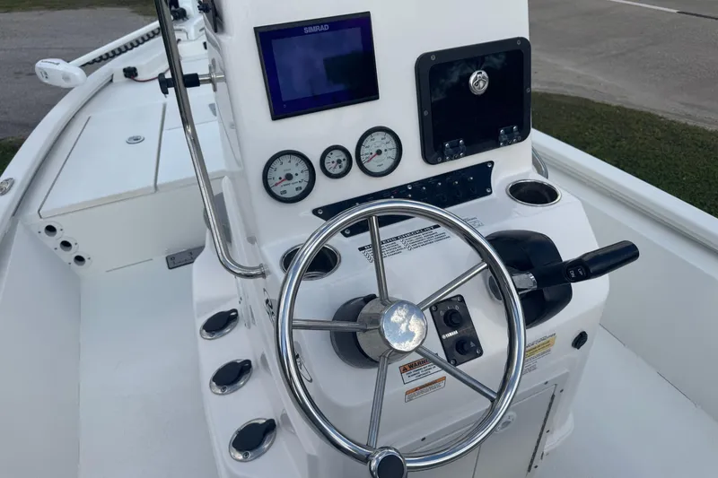 Slide: The Image of 2022 Avid 19 FS boat dashboard with steering wheel and navigation controls. - 20