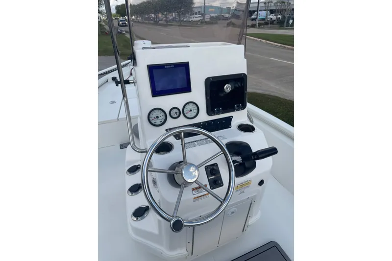 Slide: The Image of 2022 Avid 19 FS boat console with steering wheel and gauges. - 21