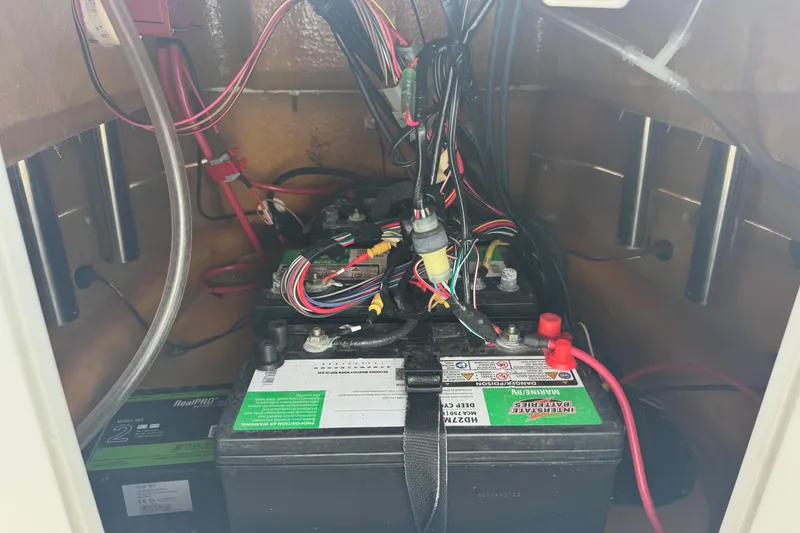 Slide: The Image of Battery compartment of 2022 Avid 19 FS boat with wiring and connections. - 22