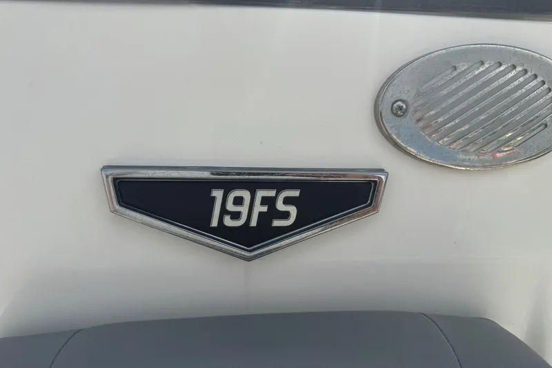 Slide: The Image of 2022 Avid 19 FS boat emblem on white surface with metal vent. - 27