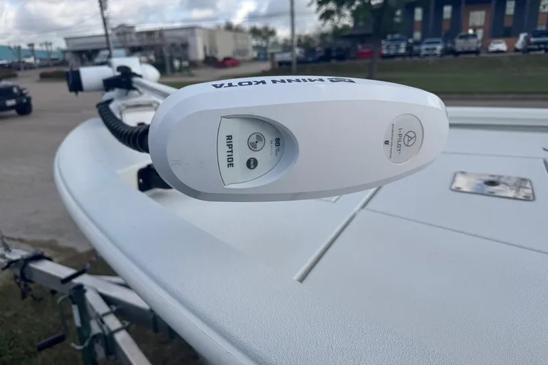 Slide: The Image of Minn Kota Riptide motor on 2022 Avid 19 FS boat, parked outdoors. - 4