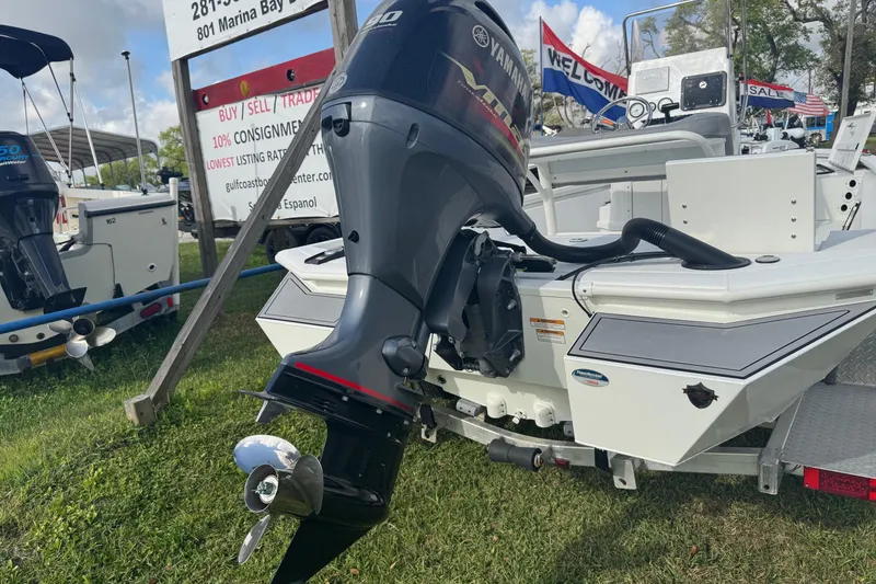 Slide: The Image of 2022 Avid 19 FS boat with Yamaha outboard motor displayed outdoors. - 6