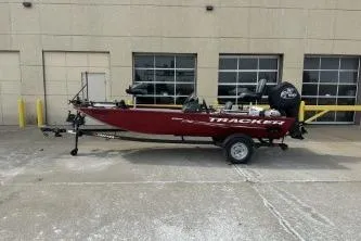 The Image of 2024 Tracker Pro 170 boat on trailer, parked outside a building. - 1