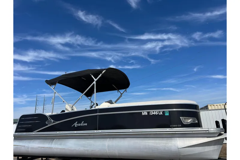 The Image of 2015 Avalon Catalina Cruise 23' pontoon boat under a clear blue sky. - 0