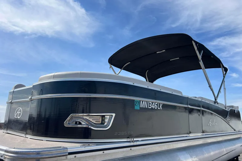 Slide: The Image of 2015 Avalon Catalina Cruise 23' pontoon boat with canopy against blue sky. - 10