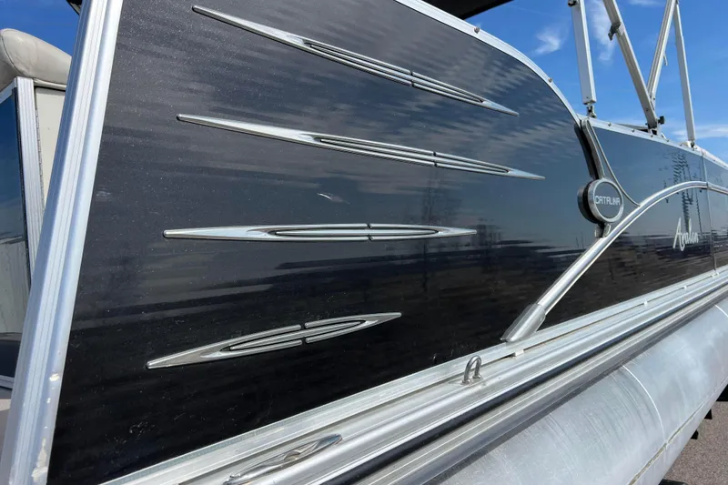 Slide: The Image of 2015 Avalon Catalina Cruise 23' pontoon boat with sleek black and silver design. - 11