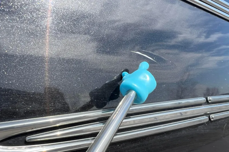 Slide: The Image of Close-up of a 2015 Avalon Catalina Cruise boat with a blue suction cup tool. - 12