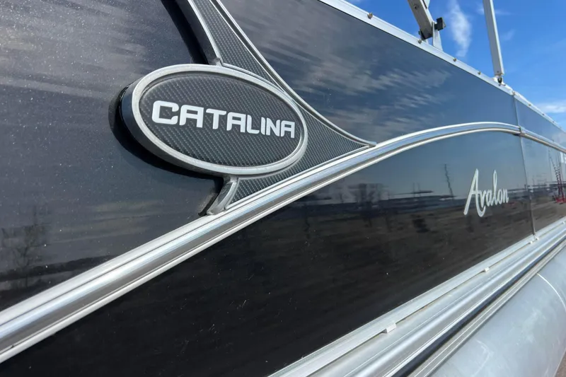 Slide: The Image of 2015 Avalon Catalina Cruise 23' boat with sleek black exterior and branding. - 13