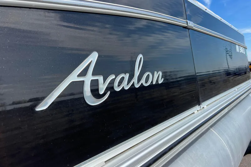 Slide: The Image of 2015 Avalon Catalina Cruise 23' boat with sleek black exterior and logo. - 14