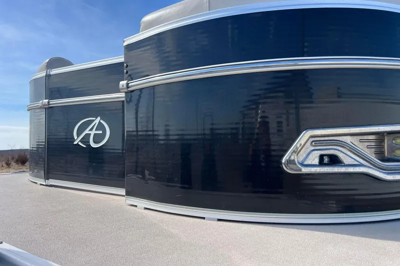 Slide: The Image of 2015 Avalon Catalina Cruise 23' pontoon boat with sleek black exterior design. - 19