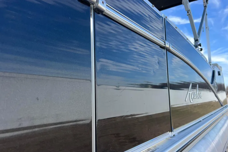 Slide: The Image of 2015 Avalon Catalina Cruise boat side view with sleek metallic finish. - 22