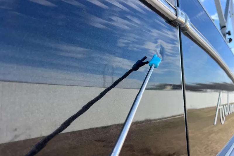 Slide: The Image of Close-up of 2015 Avalon Catalina Cruise boat exterior with reflection and blue hook. - 23