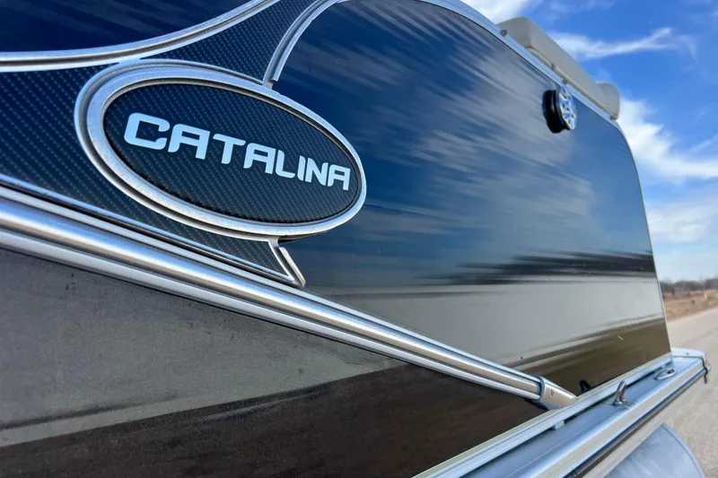Slide: The Image of 2015 Avalon Catalina Cruise boat exterior with logo, sleek design under blue sky. - 25