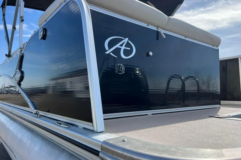 Slide: The Image of 2015 Avalon Catalina Cruise 23' pontoon boat with sleek black exterior and logo. - 26