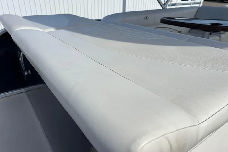 Slide: The Image of 2015 Avalon Catalina Cruise boat interior with white leather seating and wooden table. - 28