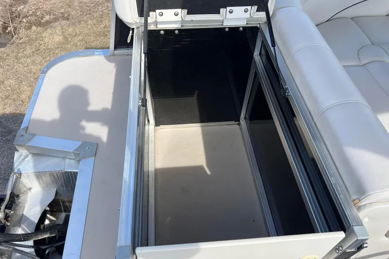 Slide: The Image of Open storage compartment on 2015 Avalon Catalina Cruise 23' boat with white seating. - 29