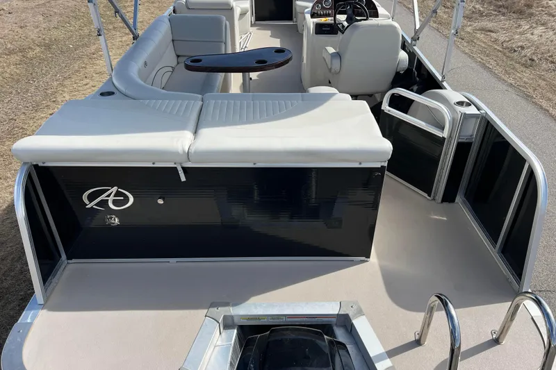 Slide: The Image of 2015 Avalon Catalina Cruise 23' pontoon boat interior with seating and steering console. - 3