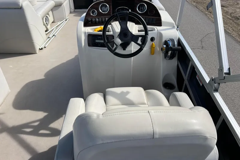 Slide: The Image of 2015 Avalon Catalina Cruise boat interior with steering wheel and seating. - 32