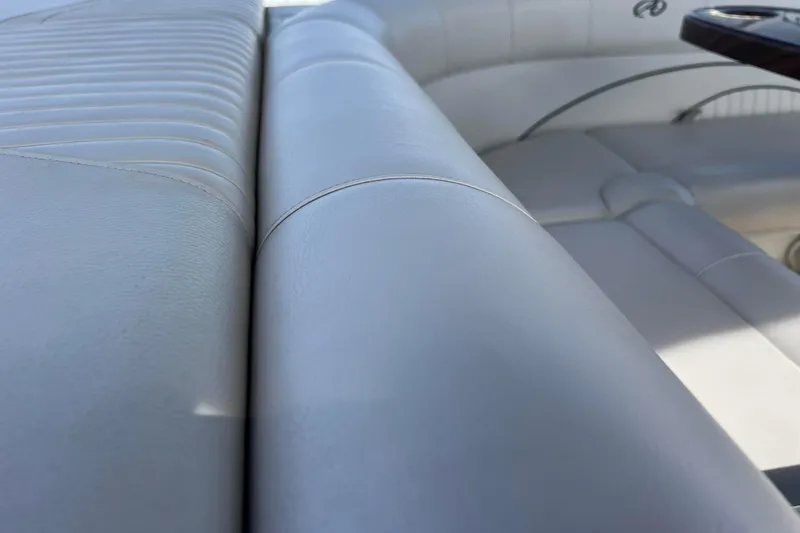 Slide: The Image of Close-up of white leather seating on a 2015 Avalon Catalina Cruise boat. - 36