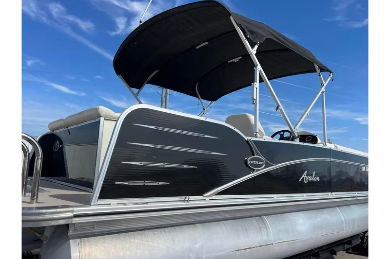 Slide: The Image of 2015 Avalon Catalina Cruise 23' pontoon boat with canopy against blue sky. - 4