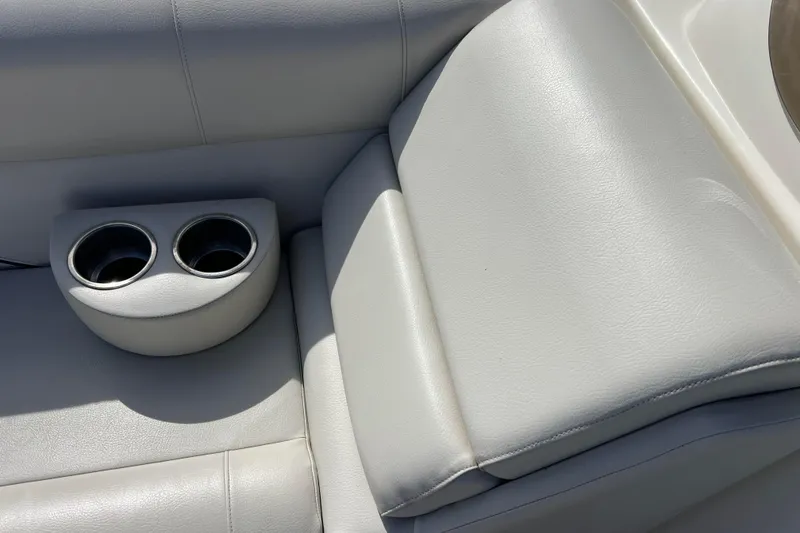 Slide: The Image of 2015 Avalon Catalina Cruise boat seat with built-in cup holders, featuring light gray upholstery. - 45