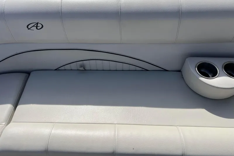 Slide: The Image of White leather seating with cup holders on a 2015 Avalon Catalina Cruise boat. - 46