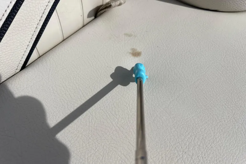 Slide: The Image of White leather seat with a small stain on a 2015 Avalon Catalina Cruise boat. - 50