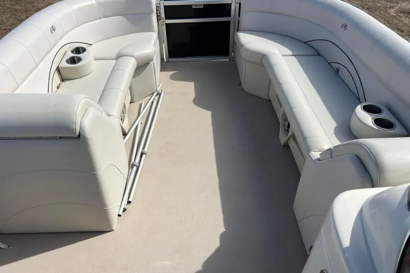 Slide: The Image of 2015 Avalon Catalina Cruise 23' boat interior with white seating and cup holders. - 56