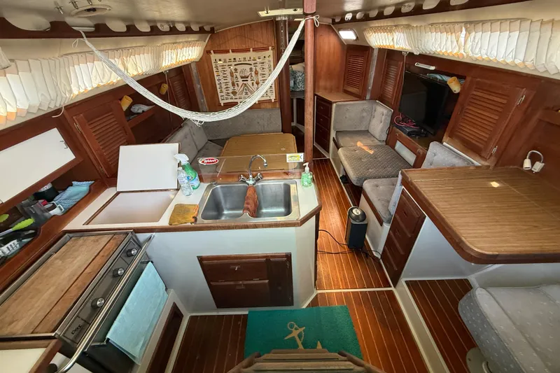 Slide: The Image of Interior of a 1987 Catalina 36 sailboat with wood finishes and cozy seating. - 16