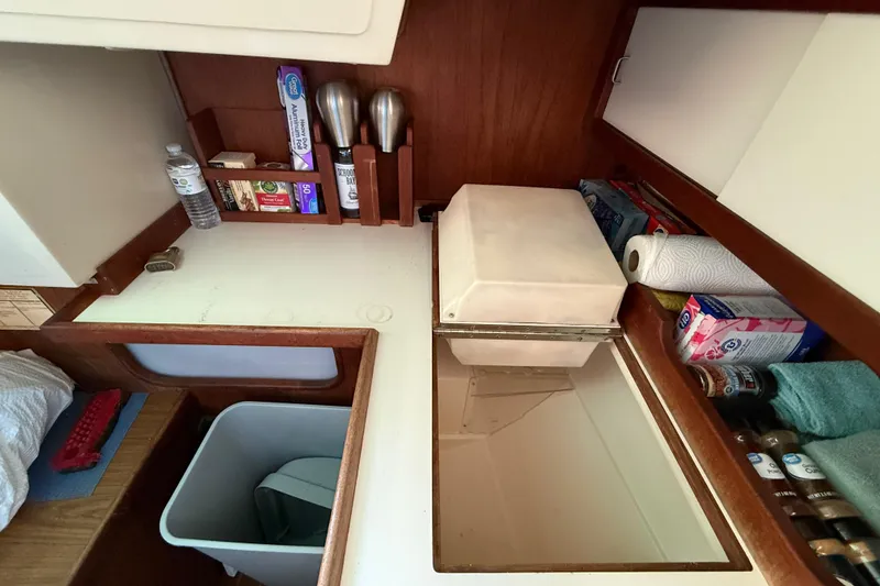 Slide: The Image of Interior of 1987 Catalina 36 sailboat kitchen with storage and supplies. - 19