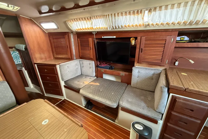 Slide: The Image of Interior of a 1987 Catalina 36 sailboat with wood paneling and cozy seating. - 22
