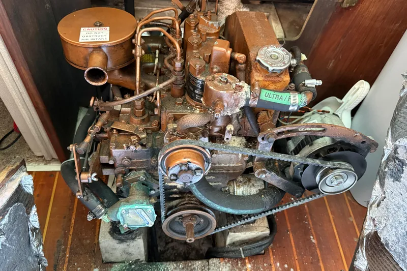 Slide: The Image of Rusty engine of a 1987 Catalina 36 sailboat, showing belts and components. - 27
