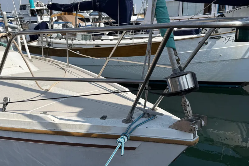 Slide: The Image of 1987 Catalina 36 sailboat bow with stainless steel railing and mooring lines. - 3