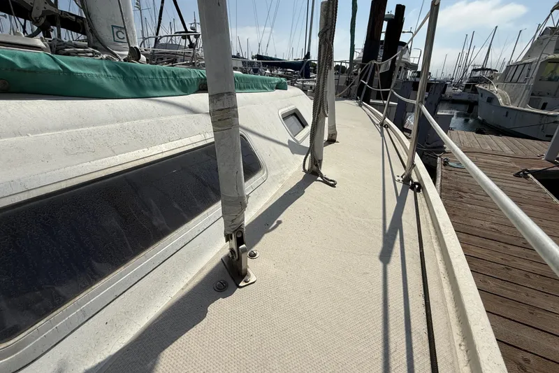 Slide: The Image of 1987 Catalina 36 sailboat deck view at marina, showcasing rigging and dock. - 5