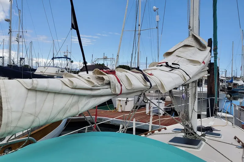 Slide: The Image of 1987 Catalina 36 sailboat with furled sail in marina setting. - 6