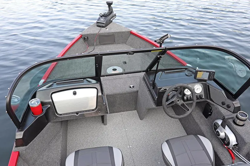 Slide: The Image of Manufacturer Provided Image: 2025 Lund 1650 Angler Sport boat interior with steering console and seating on water. - 2