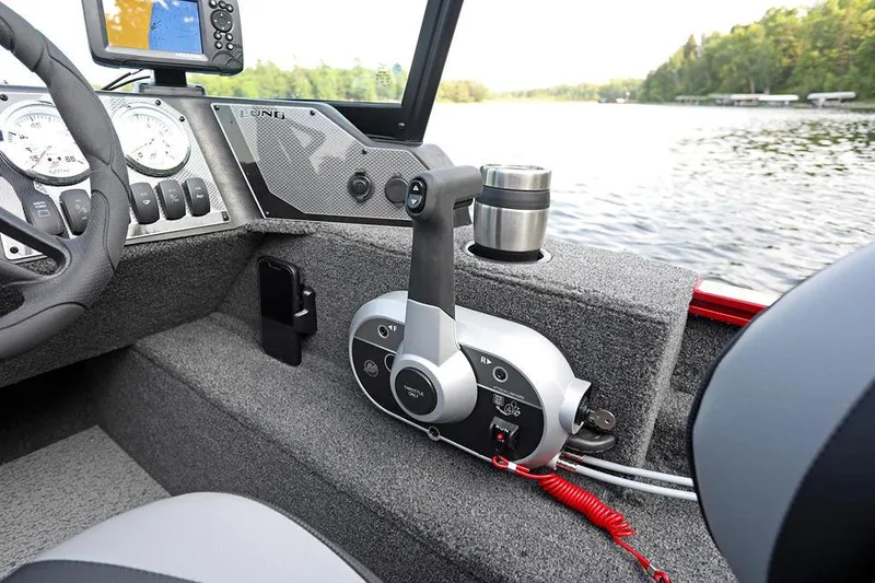 Slide: The Image of Manufacturer Provided Image: Interior of 2025 Lund 1650 Angler Sport boat with control panel and lake view. - 4