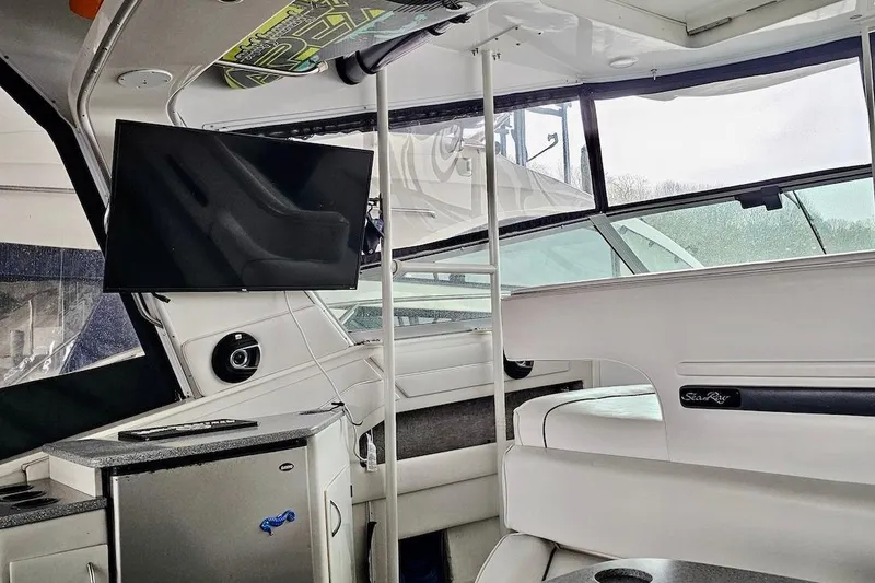 Slide: The Image of Interior of 1994 Sea Ray 440 Sundancer yacht with seating and mounted TV. - 10