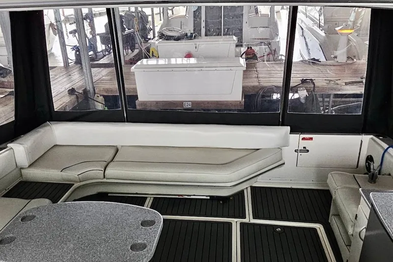 Slide: The Image of Interior of a 1994 Sea Ray 440 Sundancer with TV and mini fridge. - 12