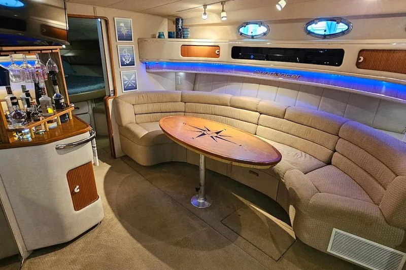 Slide: The Image of Interior of 1994 Sea Ray 440 Sundancer yacht with seating and table. - 13