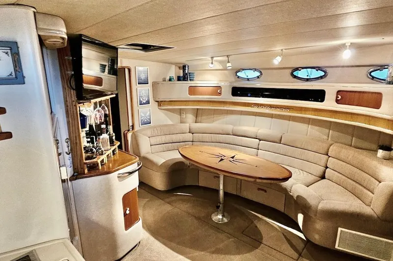 Slide: The Image of Luxurious interior of a 1994 Sea Ray 440 Sundancer yacht with plush seating and bar area. - 14