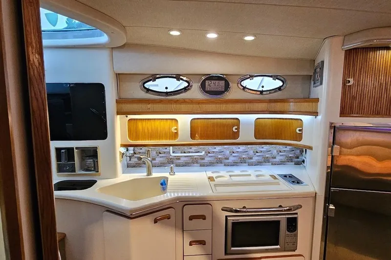 Slide: The Image of Luxurious interior of a 1994 Sea Ray 440 Sundancer yacht with elegant seating and bar area. - 17